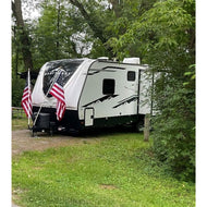 Journeyman Double RV Flag Pole Mount handcrafted from heavy-duty aluminum, shown attached to a trailer hitch for a no-drill flag display.